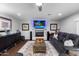 Comfortable living room featuring a fireplace, large TV, and plush seating with a ceiling fan at 3027 W Wescott Dr, Phoenix, AZ 85027