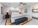 Serene main bedroom features neutral tones, a large bed, bench, and a glimpse of the en-suite bathroom at 3027 W Wescott Dr, Phoenix, AZ 85027