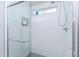 Contemporary shower stall with sleek white tiling, built-in niches, and a glass door at 3027 W Wescott Dr, Phoenix, AZ 85027