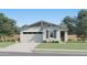 Charming single-story home with a well-manicured lawn, a two-car garage and beautiful desert landscaping at 3238 E Outlaw Ln, San Tan Valley, AZ 85140