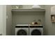 Convenient laundry area with modern washer and dryer, storage shelf, and minimalist decor at 3238 E Outlaw Ln, San Tan Valley, AZ 85140