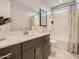 Well-lit bathroom with a single vanity, modern fixtures, and a combined shower and bathtub at 3272 E Ranchhand Dr, San Tan Valley, AZ 85140