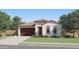 Charming single-story home with a tile roof, a well-manicured lawn, and a two-car garage at 3272 E Ranchhand Dr, San Tan Valley, AZ 85140
