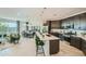 Open-concept kitchen with an island, stainless steel appliances, and a view into the dining area at 3272 E Ranchhand Dr, San Tan Valley, AZ 85140