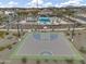 Aerial view of the community basketball court and pool surrounded by palm trees and green spaces at 3330 S Lotus Ave, Mesa, AZ 85212