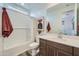Well-lit bathroom featuring a shower-tub combo, vanity, and modern decor at 3330 S Lotus Ave, Mesa, AZ 85212
