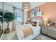 Stylish bedroom with chic decor, a large window, and an inviting ambiance at 3330 S Lotus Ave, Mesa, AZ 85212