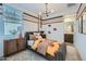 Cozy bedroom with modern décor, an accent wall, and a football theme at 3330 S Lotus Ave, Mesa, AZ 85212