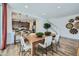 Bright dining area featuring wood floors, a table for six, and an open-concept design at 3330 S Lotus Ave, Mesa, AZ 85212