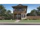 Charming two-story home with a balcony, brick accents, and desert landscaping at 3330 S Lotus Ave, Mesa, AZ 85212