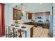 Modern kitchen with stainless appliances, dark wood cabinets, and a white countertop island at 3330 S Lotus Ave, Mesa, AZ 85212