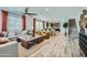 Open-concept living space with wood-style flooring, contemporary furnishings, and natural light at 3330 S Lotus Ave, Mesa, AZ 85212