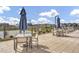 Community pool area with tables, chairs, umbrellas, and lounge chairs overlooking the neighborhood at 3330 S Lotus Ave, Mesa, AZ 85212