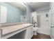 Bathroom features a white cabinet sink, large mirror, and shower with shower curtain and brown tile floors at 3432 E Bartlett Dr, Gilbert, AZ 85234