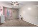 Bright bedroom featuring a window, ceiling fan, and neutral decor, offering a versatile space for children at 3432 E Bartlett Dr, Gilbert, AZ 85234