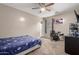 This bedroom features carpet, a ceiling fan, and light beige colored walls with a blue bed spread at 3432 E Bartlett Dr, Gilbert, AZ 85234