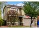 Two story house featuring a front porch with a well maintained lawn, two car garage, and shutters at 3432 E Bartlett Dr, Gilbert, AZ 85234