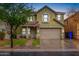 Two-story home with an attached two-car garage, manicured front yard, and American flag at 3432 E Bartlett Dr, Gilbert, AZ 85234