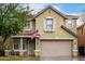 Charming two-story home featuring a neutral-colored exterior, decorative shutters, and an attached two-car garage at 3432 E Bartlett Dr, Gilbert, AZ 85234