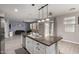Open kitchen with a central island, stainless steel appliances, and a view into the adjoining living room at 3432 E Bartlett Dr, Gilbert, AZ 85234
