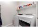 Laundry room with Whirlpool washer and dryer and white shelves at 3432 E Bartlett Dr, Gilbert, AZ 85234