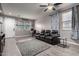 Bright living room with hardwood floors, contemporary furnishings, ceiling fan, and a cozy seating area at 3432 E Bartlett Dr, Gilbert, AZ 85234