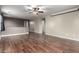 Open living room features wood floors, neutral walls, and a ceiling fan at 3432 E Bartlett Dr, Gilbert, AZ 85234