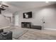 Open-concept living room with modern entertainment center, neutral colors, and hardwood flooring at 3432 E Bartlett Dr, Gilbert, AZ 85234