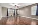 Open living room with wood floors, neutral walls, and multiple windows providing lots of natural light at 3432 E Bartlett Dr, Gilbert, AZ 85234