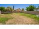 Large backyard featuring a spacious grass area bordered by a tall block fence, offering privacy and room for outdoor activities at 346 W Oxford Ln, Gilbert, AZ 85233
