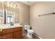 Cozy half bathroom with a vanity and a ceramic tile floor at 346 W Oxford Ln, Gilbert, AZ 85233