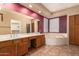 Bathroom features a dual sink vanity, soaking tub, large mirror, and wooden cabinets at 346 W Oxford Ln, Gilbert, AZ 85233