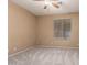 Neutral bedroom features plush carpeting, a ceiling fan, and a window with views of the outdoors at 346 W Oxford Ln, Gilbert, AZ 85233