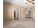 Spacious bedroom with neutral carpeting and an open doorway leading to the stairs and hall at 346 W Oxford Ln, Gilbert, AZ 85233