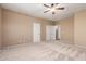 Carpeted bedroom offers closet, access to other rooms and ceiling fan at 346 W Oxford Ln, Gilbert, AZ 85233
