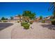 Beautiful exterior view of a well-maintained property with desert landscaping and a circular driveway at 346 W Oxford Ln, Gilbert, AZ 85233