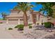 Charming home featuring a desert landscape, a mature palm tree, and a lovely courtyard fountain at 346 W Oxford Ln, Gilbert, AZ 85233