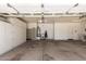 Spacious garage featuring ample storage cabinets, utility sink, and door to inside at 346 W Oxford Ln, Gilbert, AZ 85233
