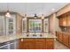 Modern kitchen island with granite countertops, double sinks, and stylish pendant lighting above at 346 W Oxford Ln, Gilbert, AZ 85233