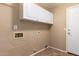 Laundry room with upper cabinets and connections for washer and dryer at 346 W Oxford Ln, Gilbert, AZ 85233