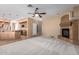 Open-concept living room with plush carpeting flowing into a stylish kitchen with granite countertops at 346 W Oxford Ln, Gilbert, AZ 85233