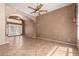 Open-concept living room with tile flooring, decorative columns, arched entryway, and French doors at 346 W Oxford Ln, Gilbert, AZ 85233