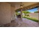 A covered patio with tiled floor, ceiling fan, built-in grill, and access to a lush backyard creates an ideal outdoor living space at 346 W Oxford Ln, Gilbert, AZ 85233