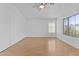 Bedroom with wood floors, ceiling fan and large window at 3478 E Park Ave, Gilbert, AZ 85234