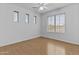 This bedroom offers a ceiling fan, wood floor, and plenty of natural light at 3478 E Park Ave, Gilbert, AZ 85234