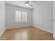 Clean bedroom with wood floors, plantation shutters, ceiling fan, and neutral walls at 3478 E Park Ave, Gilbert, AZ 85234