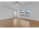 Bright bedroom with wood floors, ceiling fan and large window with view at 3478 E Park Ave, Gilbert, AZ 85234