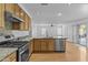 Kitchen with stainless steel appliances, granite countertops, and pass through to dining at 3478 E Park Ave, Gilbert, AZ 85234