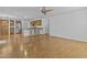 Open-concept living room featuring wood floors, a ceiling fan and views to kitchen at 3478 E Park Ave, Gilbert, AZ 85234
