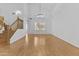 Bright living room with high ceilings, wood floors, staircase, large windows, and modern light fixture at 3478 E Park Ave, Gilbert, AZ 85234